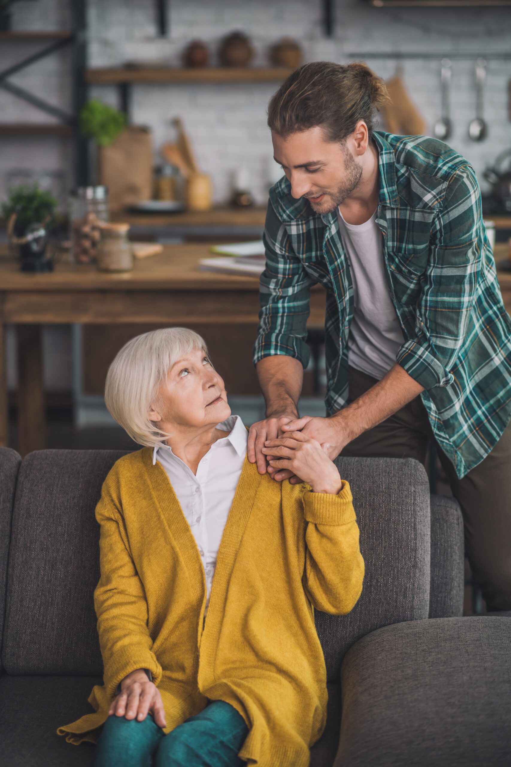 Grey-haired elderly lady feeling good with her son